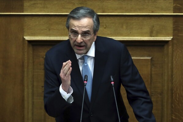 FILE - Former Prime Minister Antonis Samaras delivers a speech during a parliament session in Athens, Feb. 21, 2018. (AP Photo/Thanassis Stavrakis, File)