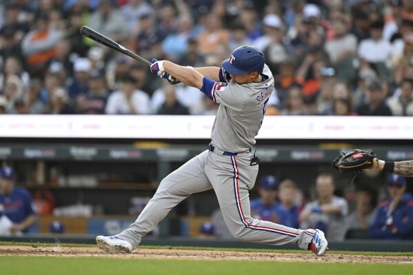 Texas Rangers' Corey Seager hits an RBI double against the Detroit Tigers during the fifth inning of a baseball game Saturday, May 10, 2025, in Detroit. (AP Photo/Lon Horwedel)