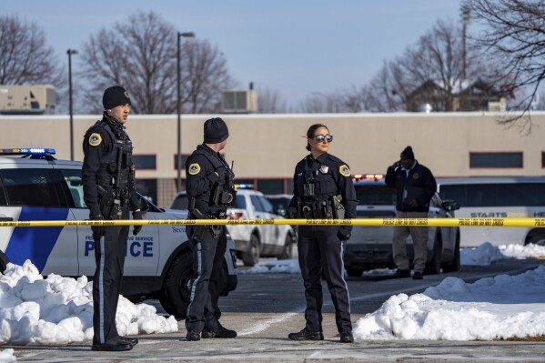 FILE - Law enforcement officers stand outside a school housing an educational program called Starts Right Here, affiliated with the Des Moines, Iowa, School District, following a shooting, Jan. 23, 2023, in Des Moines. A judge sentenced Preston Walls to 65 years in prison Thursday, Jan. 18, 2024, for killing two students at the alternative school and injuring the program's founder. (Zach Boyden-Holmes/The Des Moines Register via AP, File)