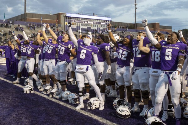 James Madison celebrates after defeating Connecticut during an NCAA college football game in Harrisonburg, Va., Saturday, Nov. 11, 2023. (Daniel Lin/Daily News-Record via AP)