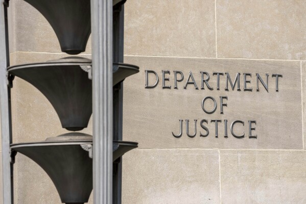 FILE - The Robert F. Kennedy Department of Justice Building is seen Friday, June 9, 2023, in Washington. An Iranian man who federal prosecutors say operates a criminal network that targets dissidents and activists abroad has been charged alongside a pair of Canadians with plotting to kill two people, including a defector from Iran, who had fled to the United States. The criminal case unsealed Monday, Jan. 29, 2024, is part of what Justice Department officials have described as a troubling trend of transnational repression, in which operatives from countries including Iran and China single out dissidents and defectors for campaigns of harassment, intimidation and sometimes violence. (AP Photo/Alex Brandon, File)