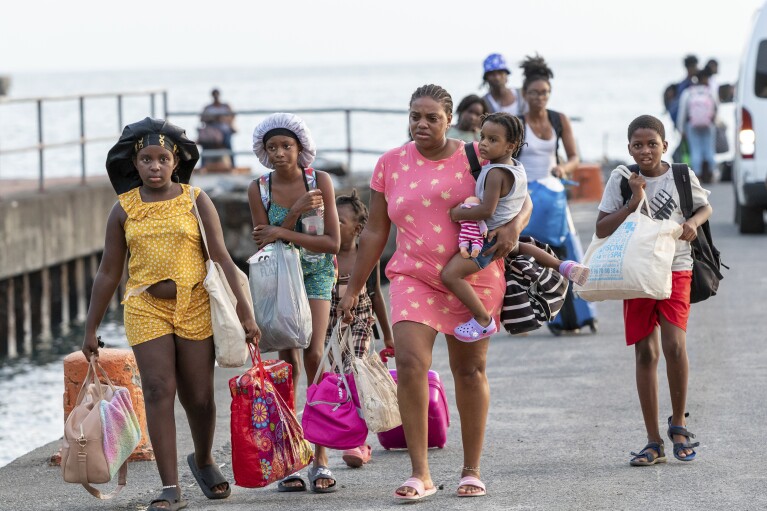 Evacuees from Union Island arrive in Kingstown, St. Vincent and the Grenadines, Tuesday, July 2, 2024. The island, in the Grenadines archipelago, was hit by Hurricane Beryl. (AP Photo/Lucanus Ollivierre)