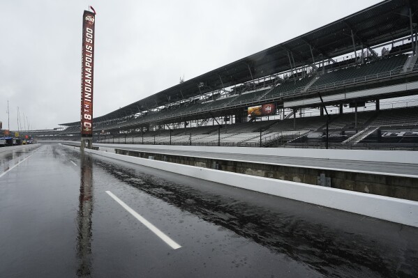 The scoring pylon is reflected on pit lane during a rain-delayed practice session for the Indianapolis 500 auto race at Indianapolis Motor Speedway, Tuesday, May 14, 2024, in Indianapolis. (AP Photo/Darron Cummings)