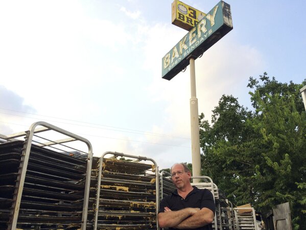 
              In this Sept. 2, 2017 photo, Bobby Jucker, owner of Three Brothers Bakery, cleans up storm damage at his bakery in Houston. In 2008, Hurricane Ike tore the roof off his business. Now he estimates he's facing $1 million in damage and lost revenue from Hurricane Harvey, the fifth time a storm has put his bakery out commission. (AP Photo/Brian Melley)
            