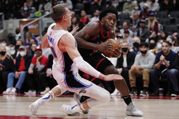 Toronto Raptors forward OG Anunoby (3) drives as Orlando Magic centre Moritz Wagner (21) defends during the second half of an NBA basketball game Friday, Oct. 29, 2021, in Toronto. (Nathan Denette/The Canadian Press via AP)