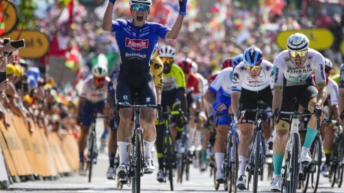 Belgium's Jasper Philipsen, left, celebrates as he crosses the finish line ahead of second placed Germany's Phil Bauhaus, right, to win the third stage of the Tour de France cycling race over 187.5 kilometers (116.5 miles) with start in Morebieta Etxano, Spain and finish in Bayonne, France, Monday, July 3, 2023. (AP Photo/Daniel Cole)