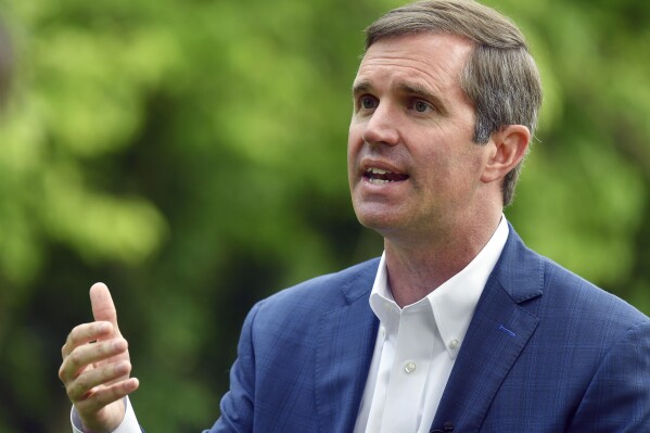 FILE - Kentucky Gov. Andy Beshear sits for an interview in Versailles, Ky., May 17, 2023. Beshear has seized a commanding fundraising lead over Republican challenger Daniel Cameron in their marquee matchup in Kentucky, their latest campaign finance reports showed. (AP Photo/Timothy D. Easley, File)