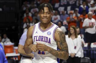 FILE - Florida forward Keyontae Johnson (11) smiles after being introduced as a starter before the first half of an NCAA college basketball game against Kentucky, on March 5, 2022, in Gainesville, Fla. Johnson, who collapsed during a game in December 2020, is headed to Kansas State to resume his college career. Johnson made the announcement on social media on Saturday, Aug. 20, 2022,  and chose the Wildcats over fellow finalists Memphis, Nebraska and Western Kentucky. (AP Photo/Matt Stamey, File)