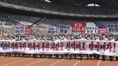 Pyongyang people take part in a demonstration after a mass rally to mark what North Korea calls 