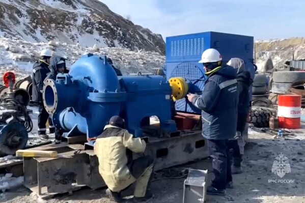 In this photo taken from video released by the Russia Emergency Situations Ministry press service on Friday, March 22, 2024, Russia Emergency Situations employees prepare to pump out water at the collapsed gold mine in Zeysk district, Amur region, eastern Russia. Rescue workers are laboring for a fifth day to reach 13 people trapped deep underground in a collapsed gold mine in Russia’s far east. News reports say no contact has been made with the miners in the Amur region, about 5,000 kilometers (3,000 miles) east of Moscow. (Russia Emergency Situations Ministry press service via AP)