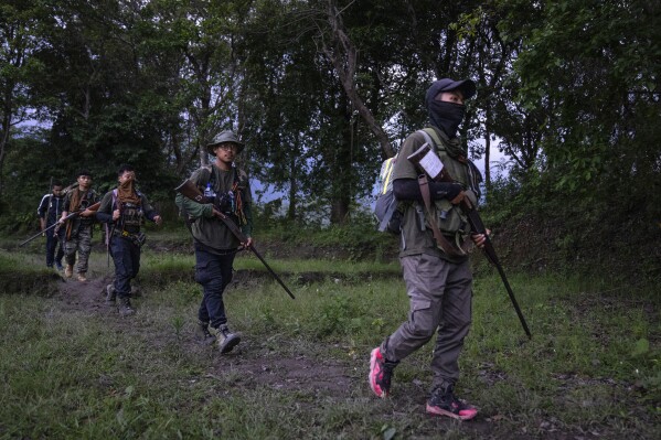 Armed tribal Kuki community members patrol near a de facto frontline dissecting the area into two ethnic zones in Churachandpur, in the northeastern Indian state of Manipur, Tuesday, June 20, 2023. Manipur is India’s unseen war – barely visible on the country’s countless TV news channels and newspapers, a conflict hidden behind the blanket shutdown of the internet. “It is as close to civil war as any state in independent India has ever been,” said Sushant Singh, a senior fellow at the Centre for Policy Research in India and an Indian army veteran. (AP Photo/Altaf Qadri)