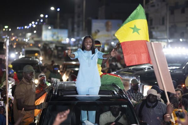 Presidential candidate Anta Babacar Ngom greets supporters during her electoral campaign caravan in Dakar, Senegal, Monday, March 11, 2024. Senegal’s only female presidential candidate may stand no chance of winning but activists say her presence alone is helping to advance a decades long campaign to achieve equality in the West African nation. (AP Photo/Sylvain Cherkaoui)