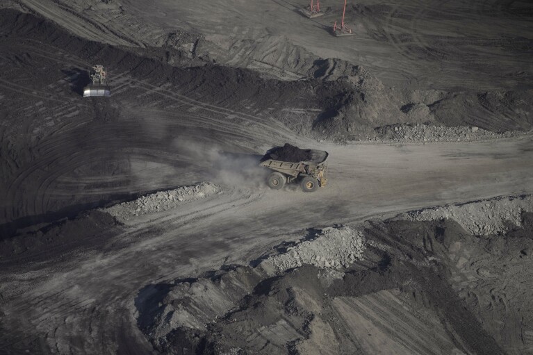 A truck carries oil sand at Suncor's facility near Fort McMurray, Canada, on Friday, Sep. 1, 2023. (AP Photo/Victor R. Caivano)