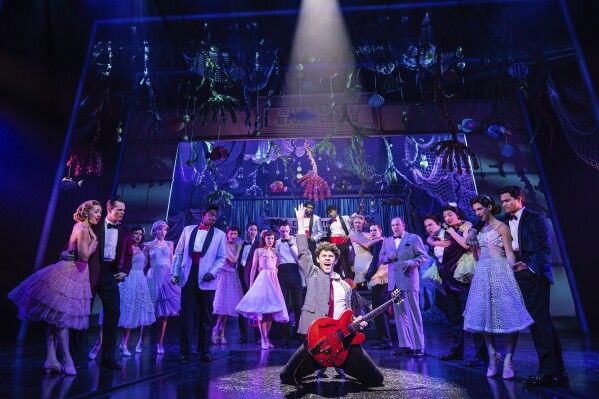 This image released by Polk & Co. shows Casey Likes, center, and the cast during a performance of "Back to the Future: The Musical." (Matthew Murphy and Evan Zimmerman via AP)