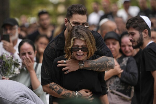 FILE - Mourners attend the funeral of Israeli soldier Abraham Cohen at the Mount Herzl cemetery in Jerusalem, Thursday, Oct. 12, 2023. The Israeli public is in a state of shock a week after Hamas militants launched an unprecedented attack on Israel, killing scores of Israelis in border communities and kidnapping roughly 150 civilians. As families grieve the dead and agonize over the missing, many also pledge allegiance to the war effort, falling in line behind a government vowing total war on the Gaza Strip. (AP Photo/Francisco Seco, File)
