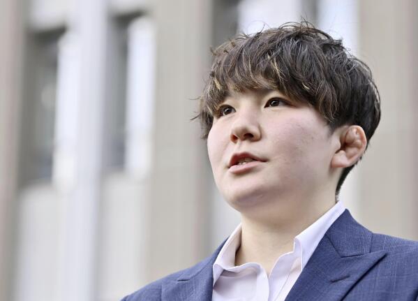 Rina Gonoi, former member of the Japan Ground Self-Defense Forces, speaks to the media after a ruling at the Fukushima District Court in Fukushima, northeastern Japan, Tuesday, Dec. 12, 2023. A Japanese court on Tuesday convicted three former soldiers in a sexual assault case that authorities had dropped until the victim, a former service member, came forward demanding a reinvestigation, prompting a military-wide harassment probe.(Kyodo News via AP)