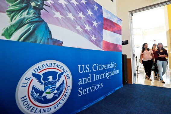 People arrive at the U.S. Citizenship and Immigration Services in Miami, Aug. 17, 2018. (AP Photo/Wilfredo Lee, File)