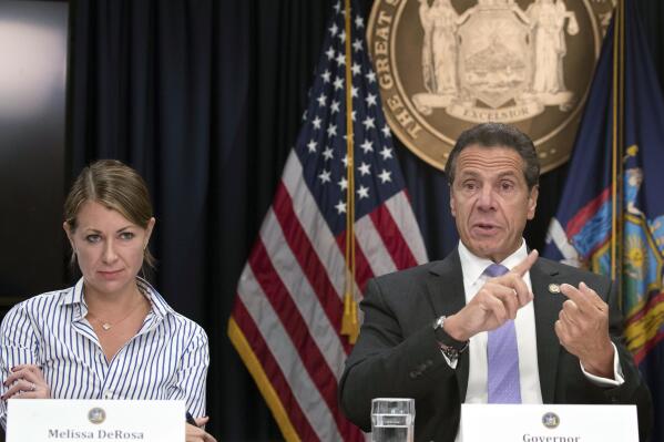 FILE - Secretary to the Governor, Melissa DeRosa, joins New York Gov. Andrew Cuomo as he speaks to reporters during a news conference on Sept. 14, 2018, in New York. In a phone interview, Monday, April 17, 2023, DeRosa described her upcoming memoir, "What's Left Unsaid: My Life at the Center of Power, Politics, and Crisis," as a chance for her to reflect, set the record straight and give an insider's account of tumultuous events. (AP Photo/Mary Altaffer, File)