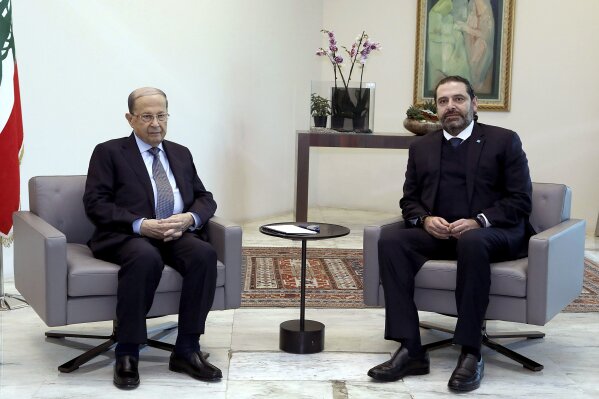 FILE - In this Dec. 19, 2019 file photo, released by Lebanese government, Lebanese President Michel Aoun, left, meets with outgoing Prime Minister Saad Hariri, right, in the presidential palace, in Baabda, east of Beirut, Lebanon. Lebanon's president called Wednesday, March 17, 2021 on the prime minister-designate to form a government immediately or step aside as the country plunges deeper into economic crisis. (Dalati Nohra/Lebanese Official Government via AP, File)