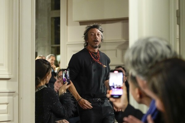 FILE - Designer Pierpaolo Piccioli accepts applause for the Valentino Haute Couture Spring-Summer 2024 collection presented in Paris, on Jan. 24, 2024. Valentino’s longtime creative director, Pierpaolo Piccioli, has announced his departure from the storied Italian fashion house. In an emotional statement shared Friday on Instagram, Piccioli reflected on his 25-year tenure with the brand, thanking co-founders Valentino Garavani and Giancarlo Giammetti and the team that contributed to the brand’s success during his time. (AP Photo/Thibault Camus, File)