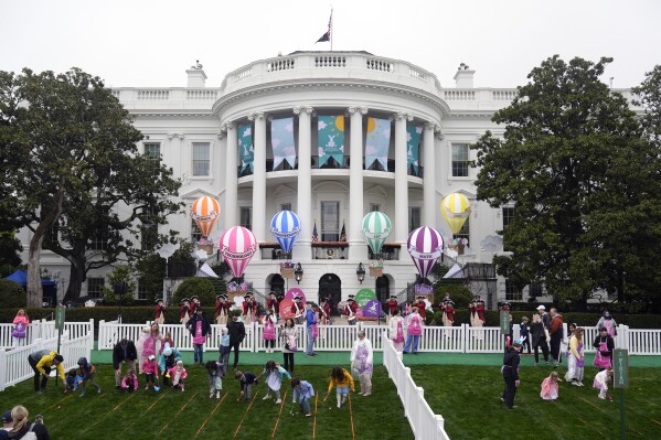 The White House Easter Egg Roll begins on the South Lawn of the White House in Washington, Monday, April 1, 2024. Thunder and lightning delayed the start of the Easter egg roll at the White House for 90 minutes on Monday, but the event eventually kicked off under gray skies and internment rain. More than 40,000 people, 10,000 more than last year, were expected to participate in the event. (AP Photo/Mark Schiefelbein)
