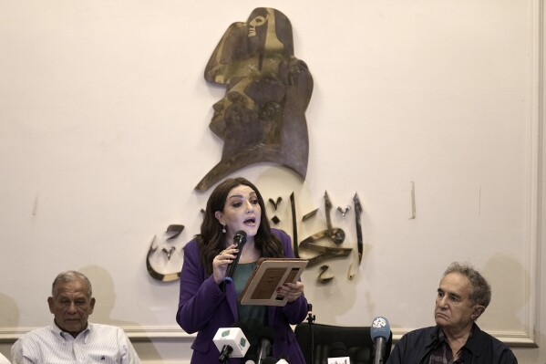 Gameela Ismail, center, the head of Egypt's al-Dostour Party, speaks during a presser held by the Free Current coalition in Cairo, Egypt, Monday, Aug. 28, 2023. A new coalition of Egyptian political parties has publicly criticized the country's current government on Monday for persecuting politicians. In a presser Monday a spokesmen for the coalition said the practices of the current government are a danger to the country's future. (AP Photo/Amr Nabil)