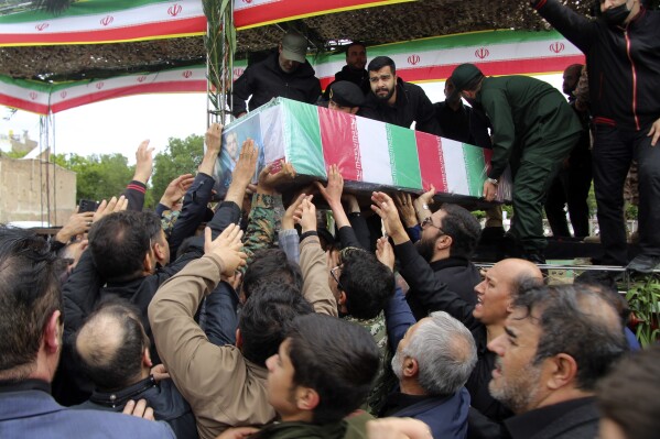 In this photo provided by Fars News Agency، mourners carry the flag-draped coffin of Iranian Foreign Minister Hossein Amirabdollahian، who was killed in a helicopter crash along with President Ebrahim Raisi on Sunday in a mountainous region of the country's northwest، during a funeral ceremony at the city of Tabriz، Iran، Tuesday، May 21، 2024. Mourners in black began gathering Tuesday for days of funerals and processions for Iran's late president، foreign minister and others killed in a helicopter crash، a government-led series of ceremonies aimed at both honoring the dead and projecting strength in an unsettled Middle East. (Ata Dadashi، Fars News Agency via AP)