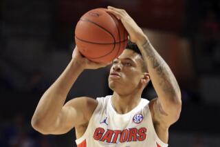 FILE - In this Jan. 25, 2020, file photo, Florida forward Keyontae Johnson (11) takes a shot against Baylor during the first half of an NCAA college basketball game in Gainesville, Fla. Johnson hasn't practiced or played since collapsing on the court last December. (AP Photo/Matt Stamey, File)