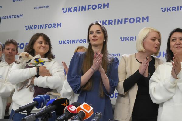 Center for Civil Liberties head of the board Oleksandra Matviychuk, center, executive director Oleksandra Romantsova, center left, and managers react after press conference in Kyiv, Ukraine, Saturday, Oct. 8, 2022. On Friday, Oct. 7, 2022 the Nobel Peace Prize was awarded to jailed Belarus rights activist Ales Bialiatski, the Russian group Memorial and the Ukrainian organization Center for Civil Liberties. (AP Photo/Efrem Lukatsky)