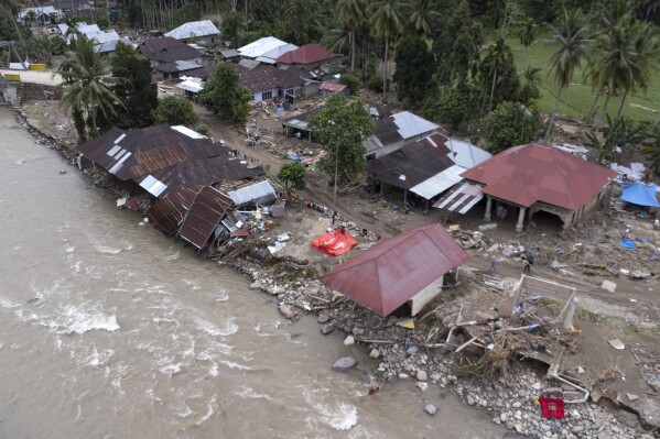 Homes damaged by a flash flood sit in Pesisir Selatan, West Sumatra, Indonesia, Wednesday, March 13, 2024. In Indonesia, environmental groups continue to point to deforestation and environmental degradation worsening the effects of natural disasters such as floods, landslides, drought and forest fires. (AP Photo/Sutan Malik Kayo)