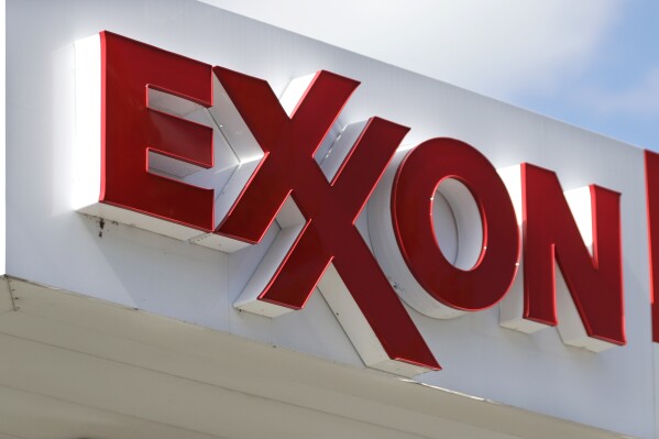 FILE- An Exxon service station sign is seen, April 25, 2017, in Nashville, Tenn. Exxon Mobil is buying pipeline operator Denbury, the beneficiary of changes in U.S. climate policy that intended to reduce the amount of emissions released into the atmosphere. Exxon Mobil Corp. said Thursday, July 13, 2023, that the acquisition gives it the largest owned and operated carbon dioxide pipeline network in the U.S. at 1,300 miles. (AP Photo/Mark Humphrey, File)