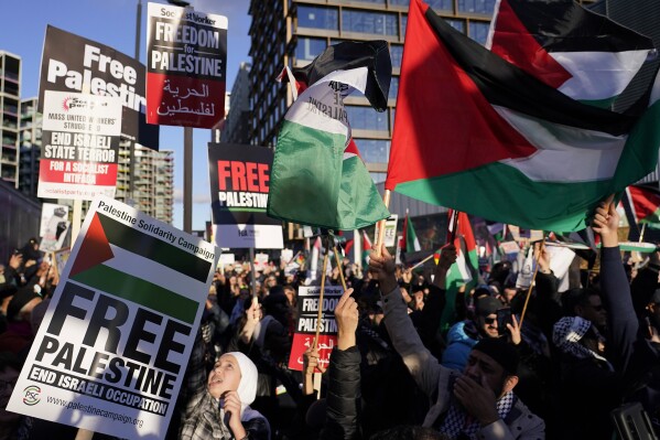 Protesters wave flags during a pro-Palestinian protest in London, Saturday, Nov. 11, 2023. London police have stepped up efforts to ensure a pro-Palestinian march on Saturday remains peaceful following a week of political sparring over whether the demonstration should go ahead on the weekend Britain honors its war dead.(AP Photo/Alberto Pezzali)