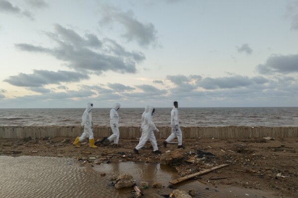 FILE - Rescuers search for bodies of the flood victims at the Corniche of the city of Derna, Libya, Sept. 15, 2023. The devastating storm that dumped torrential rains along the Libyan coast this month was up to 50 times more likely to occur and 50% more intense because of human-caused climate change, according to an analysis released Tuesday, Sept. 19. (AP Photo/Abdulaziz Almnsori, File)