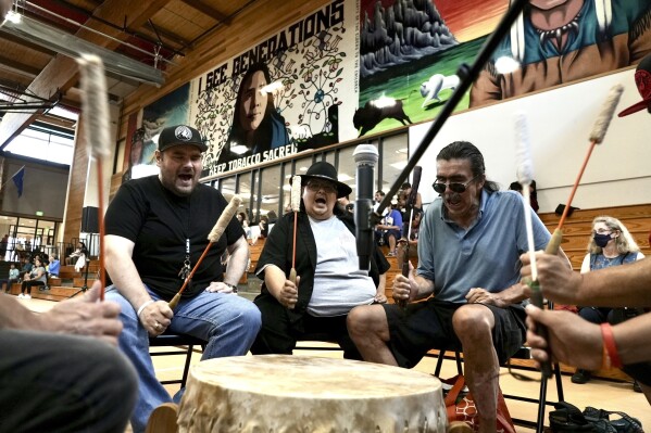 Mark Erickson, third from left, leads others in singing on the drum during an open drum and dance night at Minneapolis American Indian Center on Wednesday, July 10, 2024, in Minneapolis, Minn. (ĢӰԺ Photo/Mark Vancleave)