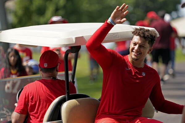 Kansas City Chiefs quarterback Patrick Mahomes waves to fans after NFL football training camp Sunday, July 23, 2023, in St. Joseph, Mo. (AP Photo/Charlie Riedel)