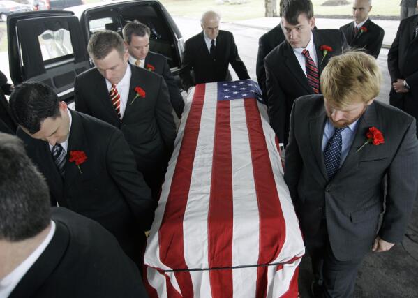 FILE - Pallbearers carry the casket of John Granville, the American diplomat killed in Sudan, at his funeral at St. John Vianney R.C. Church in Orchard Park, N.Y., Jan. 9, 2008. The U.S. said Wednesday, Jan. 1, 2023, that it is “deeply concerned" by Sudan's release of a man convicted in the 2008 killing of Granville, a U.S. diplomat, and an embassy employee in a drive-by shooting in the Sudanese capital, Khartoum. (AP Photo/David Duprey, File)