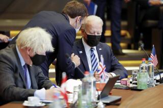 FILE - In this June 14, 2021, file photo French President Emmanuel Macron, center, speaks with U.S. President Joe Biden, right, during a plenary session at a NATO summit in Brussels. Ties between the United States and its oldest ally, France, have long been fraternal, but they've also been marked by deep French unease over their equality. French concerns about being the junior partner in the relationship boiled over last week when the U.S., Britain and Australia announced a new security initiative for the Indo-Pacific.  (AP Photo/Olivier Matthys, Pool, File)