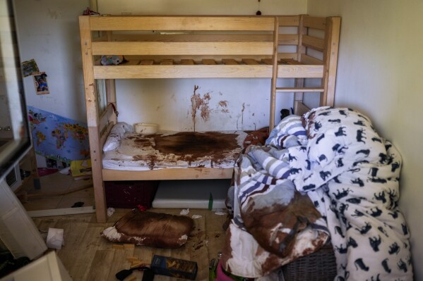 Blood is splattered in a child's room following a massive Hamas militant attack in Kibbutz Nir Oz, Israel, Thursday, Oct. 19, 2023. Nir Oz is one of more than 20 towns and villages in southern Israel that were ambushed in the sweeping assault by Hamas on Oct. 7. The kibbutz on a low rise overlooking the border fence with Gaza suffered a particularly harsh toll with about 100 of Nir Oz's 400 people dead or missing. (AP Photo/Francisco Seco)