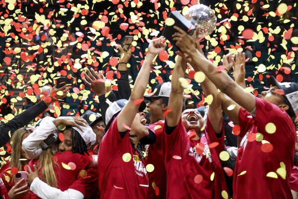 Southern California's India Otto hugs Aaliyah Gayles while teammates McKenzie Forbes, JuJu Watkins and Rayah Marshall celebrate during the second half of an NCAA college basketball game in the championship of the Pac-12 tournament Sunday, March 10, 2024, in Las Vegas. (AP Photo/Ian Maule)