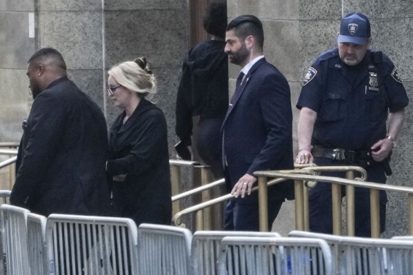 Stormy Daniels, second from left, exits the courthouse in New York, Tuesday, May 7, 2024. Porn actor Daniels, whose real name is Stephanie Clifford, took the stand mid-morning Tuesday and testified about her alleged sexual encounter with Trump in 2006, among other things. (AP Photo/Seth Wenig)