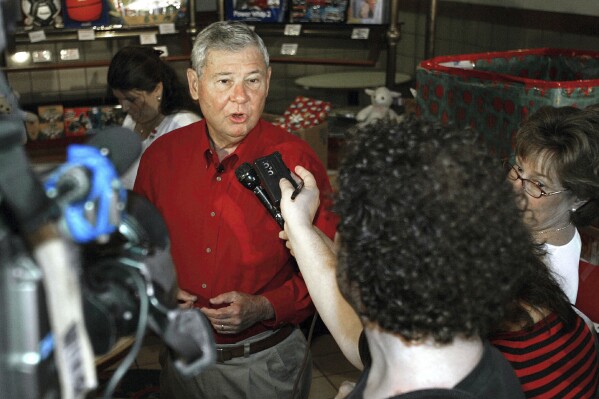 FILE - Sen. Bob Graham, D-Fla., speaks with the media during his 408th and final workday in Islamorada, Fla., Wednesday, Dec. 22, 2004. Graham, who gained national prominence as chairman of the Senate Intelligence Committee in the aftermath of the 2001 terrorist attacks and as an early critic of the Iraq war, has died, Tuesday, April 16, 2024. He was 87. (AP Photo/Hillery Smith Shay, File)