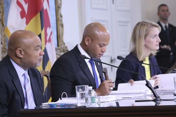 FILE - Maryland Gov. Wes Moore, center; Treasurer Dereck Davis, left; and Comptroller Brooke Lierman, right, who comprise the Board of Public Works, are seen, Nov. 8, 2023, in Annapolis, Md. Maryland officials approved more than $3 million on Wednesday, May 1, 2024, for Gary Washington, a Baltimore man who was wrongly convicted of murder and spent more than 31 years in prison for a crime he didn't commit. Moore apologized to Washington during a Board of Public Works meeting where the compensation was approved. (AP Photo/Brian Witte, File)