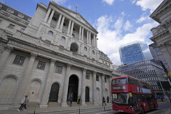 FILE - A bus drives past the Bank of England before the release of the Monetary Policy Report at the Bank of England in London, Thursday, May 5, 2022. The Bank of England is under pressure to raise interest rates more aggressively amid concern that the quarter-percentage-point hike expected Thursday will do little to combat price increases that have pushed inflation to a 40-year high. (AP Photo/Frank Augstein, File)