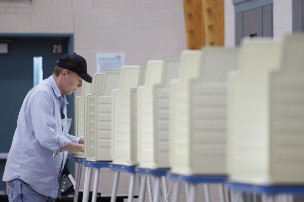 Kim Wilcox casts his ballot in the Omaha municipal election at Black Elk Elementary School, Tuesday, May 13, 2025, Omaha, Neb. (Nikos Frazier/Omaha World-Herald via AP)