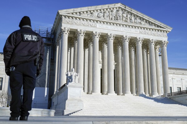 A U.S> Supreme Court police officer patrols outside the U.S Supreme Court Friday, Jan. 5, 2024, in Washington. The Supreme Court will decide whether former President Donald Trump can be kept off the 2024 presidential ballot because of his efforts to overturn his 2020 election loss that culminated in the U.S. Capitol attack. The justices Friday agreed to take a Colorado case, inserting themselves in the presidential campaign and acknowledging the need to decide quickly. (AP Photo/Mariam Zuhaib)