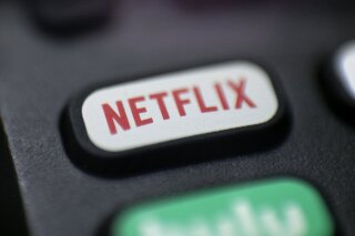 FILE - This Aug. 13, 2020  photo shows a logo for Netflix on a remote control in Portland, Ore. Netflix Inc. (NFLX) on Tuesday, Oct. 20, 2020 reported third-quarter net income of $790 million. The Los Gatos, California-based company said it had profit of $1.74 per share. (AP Photo/Jenny Kane, File)