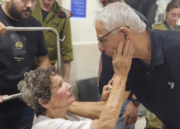 In this photo provided by Ichilov hospital, Yocheved Lifshitz, one of the two women released from Hamas captivity late Monday, Oct. 23, 2023, meets people at the hospital in Tel Aviv, Israel. (Jenny Yerushalmy/Ichilov hospital via AP)