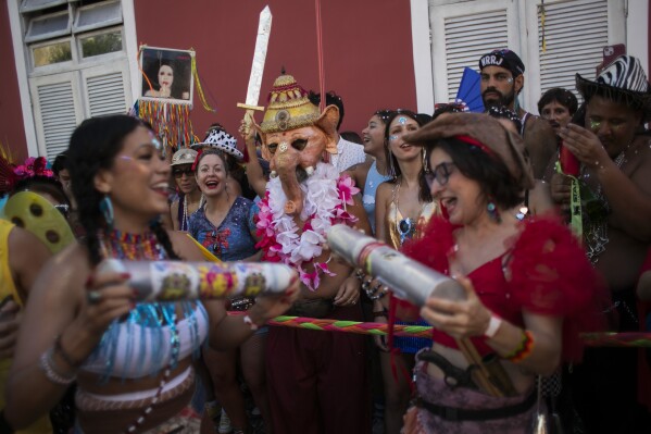 A reveler dressed as Ganesha, a Hindu deity, center, watches the "Ceu na Terra" or "Heaven on Earth" Carnival street party in Rio de Janeiro, Saturday, March 1, 2025. (AP Photo/Bruna Prado)