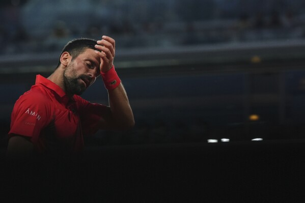 Serbia's Novak Djokovic wipes his face during a third-round match against Austria's Filip Misolic in the French Tennis Open at the Roland-Garros stadium in Paris, Saturday, May 31, 2025. (AP Photo/Lindsey Wasson)