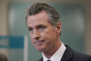FILE - In this July 26, 2021, file photo, California Gov. Gavin Newsom appears at a news conference in Oakland, Calif. The Orange County Board of Education in Southern California announced plans to sue Newsom over a state mandate requiring K-12 students to wear masks in classrooms. (AP Photo/Jeff Chiu, File)